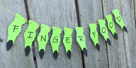 green finger food bunting on a wooden fence with the words finger food hanging from it