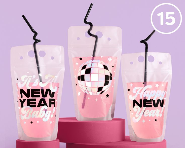 three new year's cups with straws in them sitting on top of each other