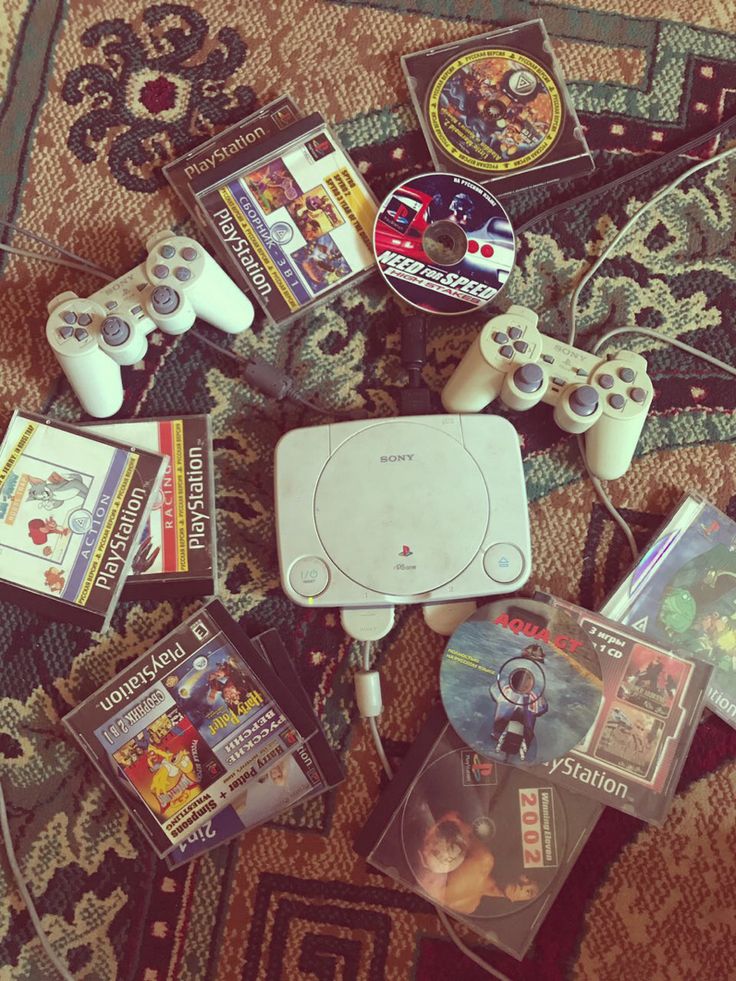 a pile of video game equipment sitting on top of a rug