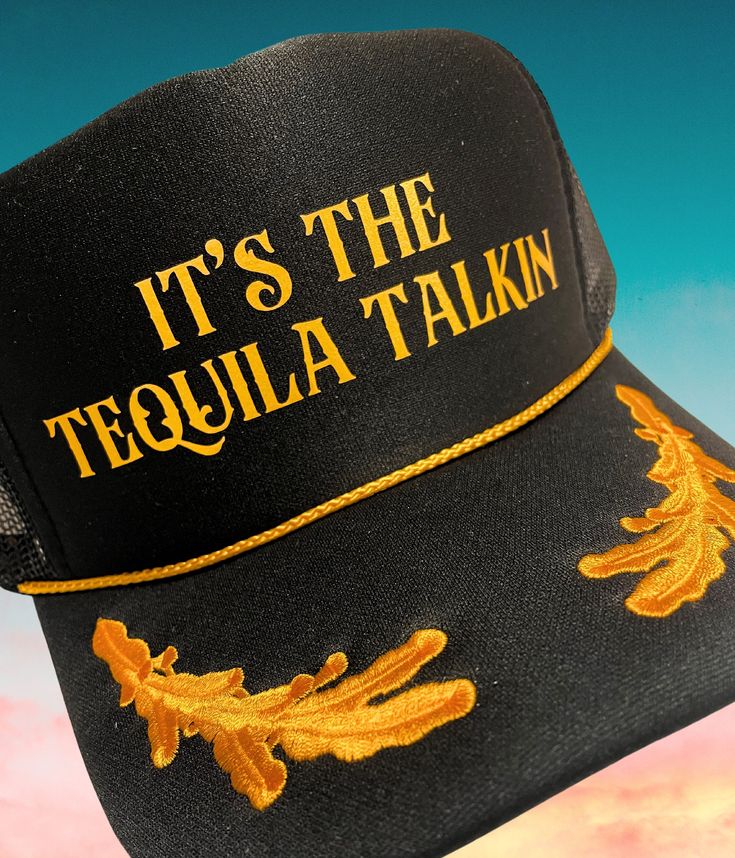 "Welcome to our Etsy listing for the \"It's the Tequila Talkin' Black and Gold Captain Sailor Trucker Hat\"! This statement-making trucker hat is perfect for those who love tequila and want to make a stylish impact. With its black and gold color combination, this hat stands out from the crowd. The captain sailor design adds a touch of nautical flair, making it a unique and eye-catching accessory. Made with high-quality materials, this hat is not only fashionable but also comfortable to wear. The adjustable strap ensures a perfect fit for all head sizes. Express your love for tequila and showcase your fun-loving spirit with this must-have hat. Whether you're hitting the beach, partying with friends, or simply enjoying a night out, this hat is the perfect companion. It's also a fantastic gif Trucker Hat Bar, Diy Hats, Captain Cap, Fun Hats, Hat Bar, Trucker Hat Black, Gold Color Combination, Custom Bachelorette, Custom Trucker Hats