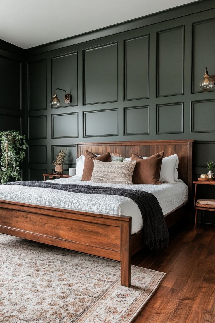 a bedroom with dark green walls and wooden bed frame in the middle, along with rugs on hardwood flooring