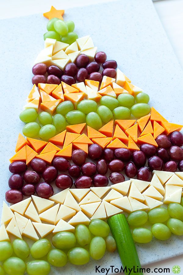 a christmas tree made out of cheese and grapes