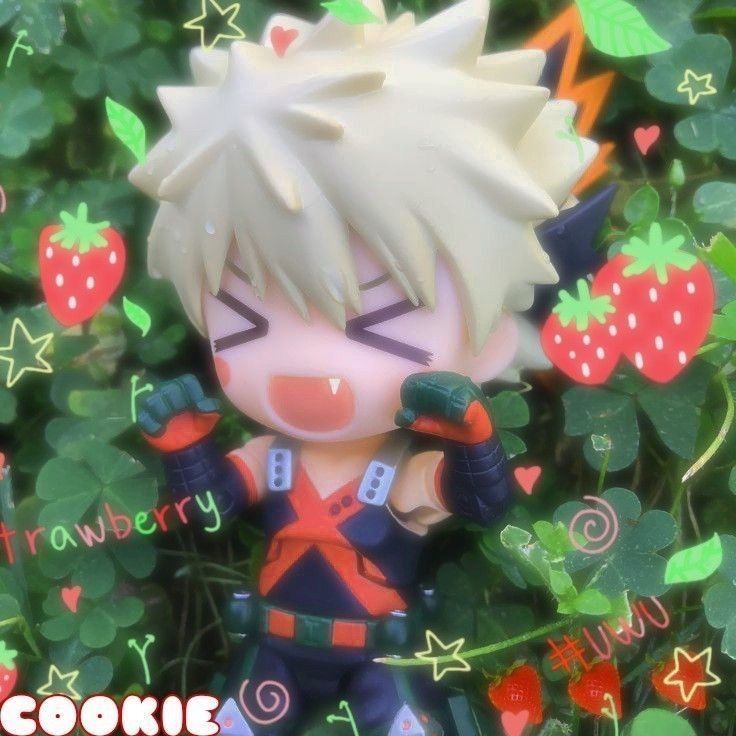 an anime figurine is standing in the grass with strawberries on it's head