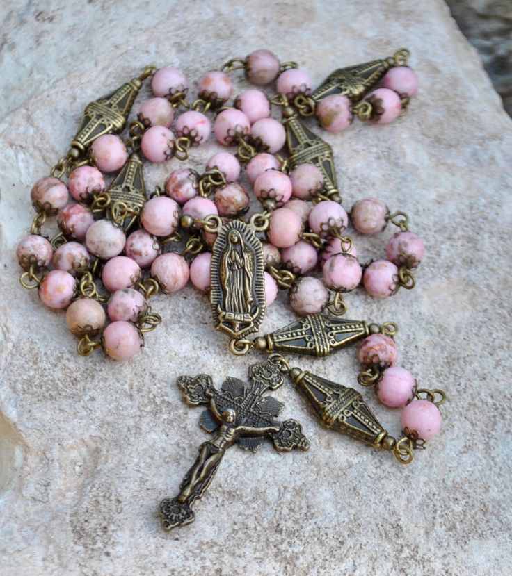 Handmade rosary made with natural pink jasper beads, findings and religious rosary connectors. Rosary long: 30 inch long Please check out our SHOP POLICY and SHOP ANNOUNCEMENT before you make any payment, thank you. http://www.etsy.com/shop/rbckcreations/policy Thanks for taking a look and stopping by my shop! Beautiful Rosaries, Pink Jasper, Pinterest Wardrobe, Handmade Rosary, Our Lady Of Guadalupe, Lady Of Guadalupe, Wire Work Jewelry, Back Jewelry, Work Jewelry