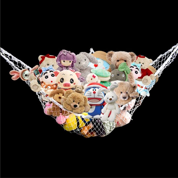 a bunch of stuffed animals are in a hammock on a black background,