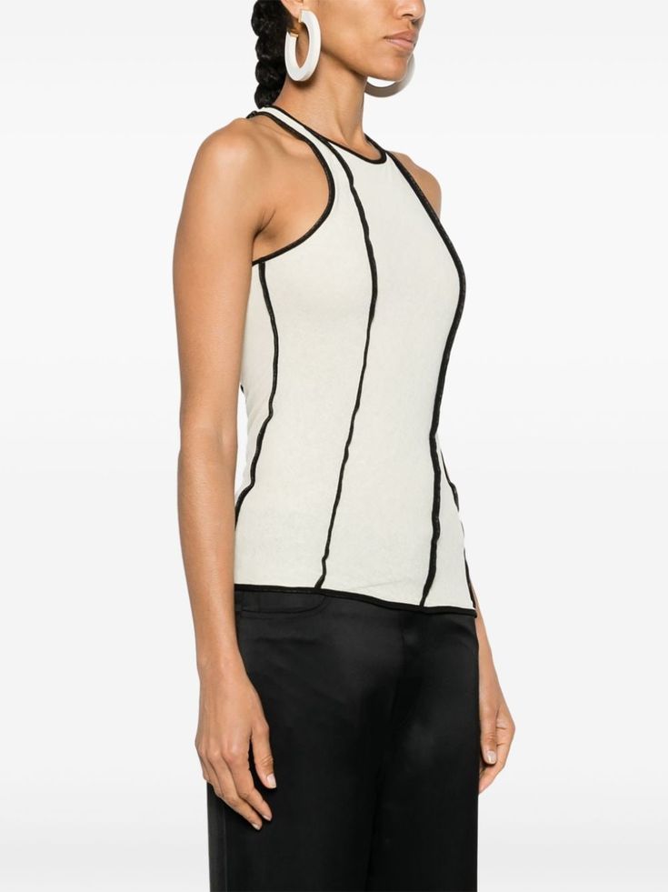 Find NANUSHKA Enna Tank Top on Editorialist. ivory white/black recycled polyester jersey texture double layer contrasting piped-trim detailing round neck sleeveless racerback straight hem pull-on style This item is made from at least 50% recycled or upcycled materials. For recycled synthetic clothing products, we highly recommend using a microfibre-catching washing bag to ensure that no microplastics that can pollute water are released in the process. We've partnered with Good On You — an independent agency that rates how brands perform in relation to their impact on the planet, people and animals, with a multi-criteria rating simplified to a five points scale. In order to be awarded our conscious label, larger brands need to score a minimum of four out of five ('Good'), while smaller bran Fitted Sleeveless Tank Top With Contrast Trim, White Fitted Top With Contrast Trim, Fitted White Top With Contrast Trim, White Fitted Tank Top With Contrast Trim, Fitted White Tank Top With Contrast Trim, Casual Fitted Tank Top With Contrast Trim, Modern Fitted White Tank Top, Versatile White Tank Top For Work, Stretch Sleeveless Top With Contrast Trim