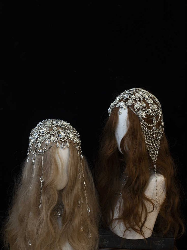 two mannequins with headpieces on top of them