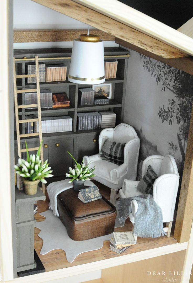 a doll house living room with furniture and bookshelf in the corner, as well as an open bookcase