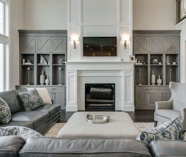 a living room filled with furniture and a fire place in the middle of a room