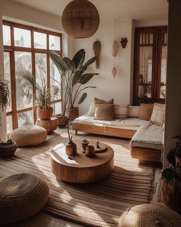 a living room filled with lots of furniture and plants