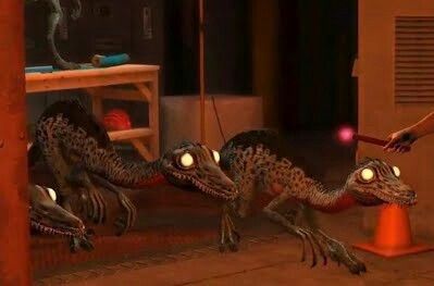 an animated image of two dinosaurs chasing each other in the same direction as a person