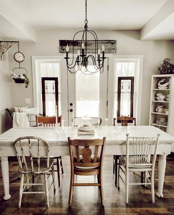 a dining room table with chairs and a chandelier