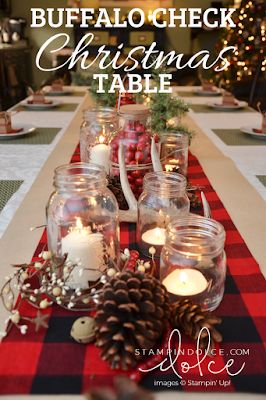 the table is set with candles, pine cones and other decorations for christmas tablescape