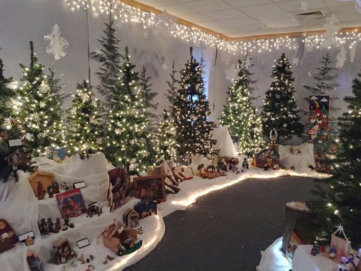 a room with christmas trees and lights on the walls