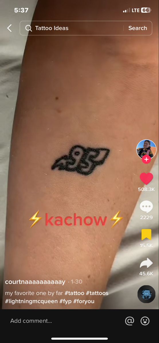 a person with a tattoo on their arm and the words kachow above it