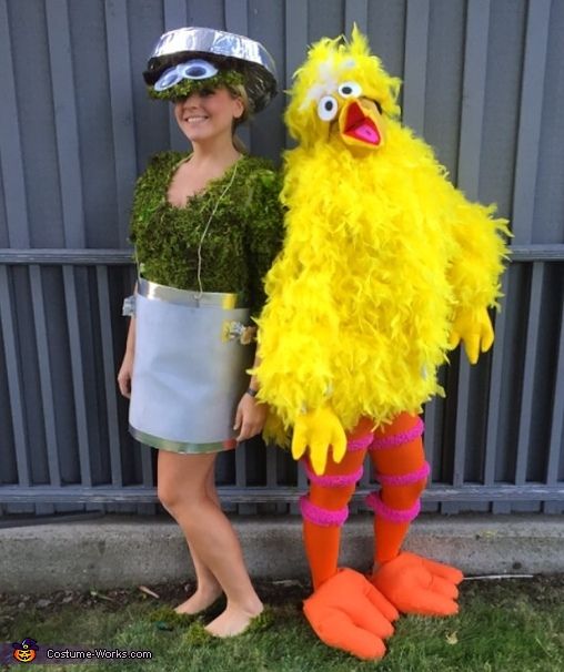 a woman standing next to a large yellow bird