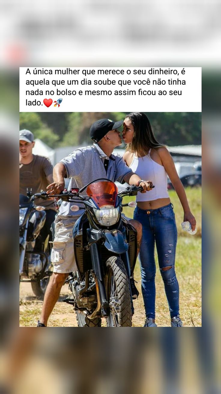 a man kissing a woman on the cheek while standing next to a motorbike