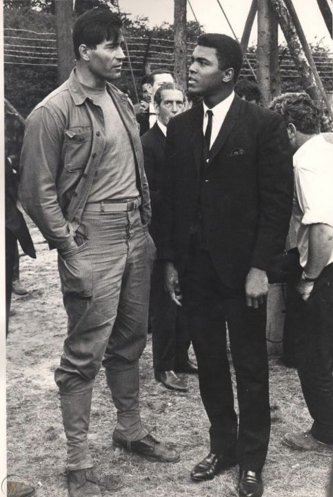 two men in suits standing next to each other