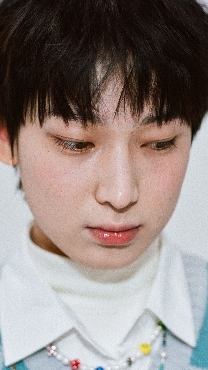 a close up of a person wearing a shirt and tie