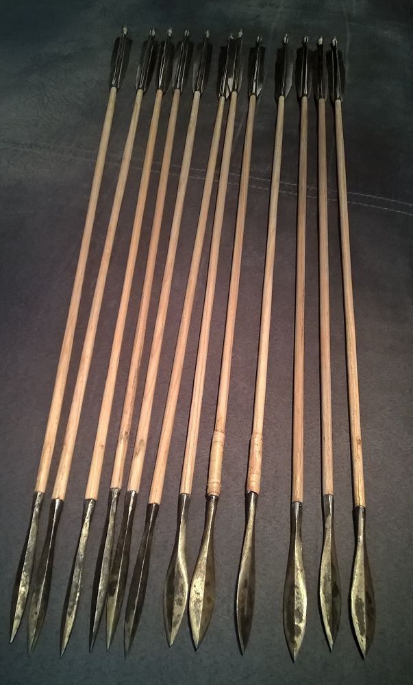 six wooden arrows are lined up in a row