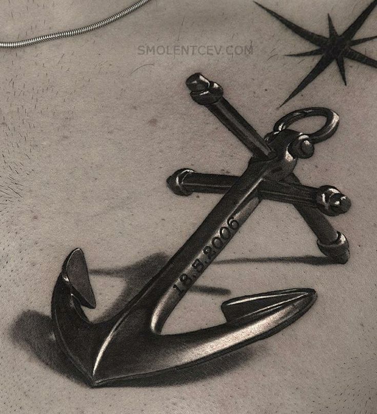 an anchor and compass tattoo on the chest