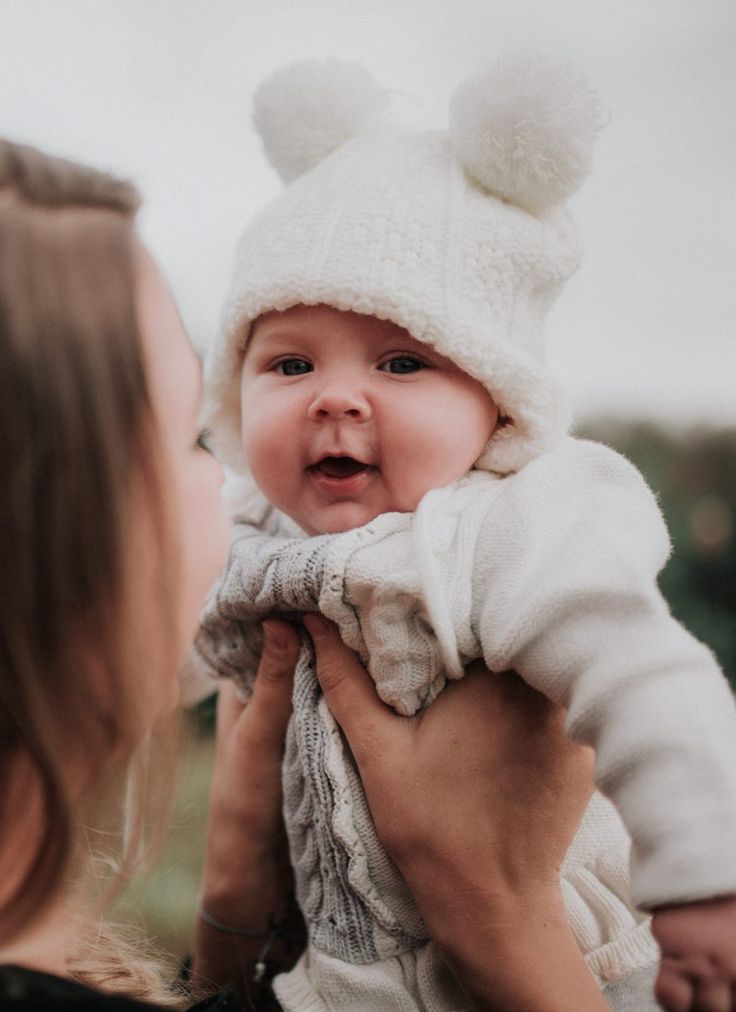 a woman holding a baby in her arms