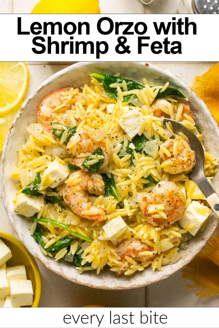 lemon orzo with shrimp and feta in a white bowl next to sliced lemons