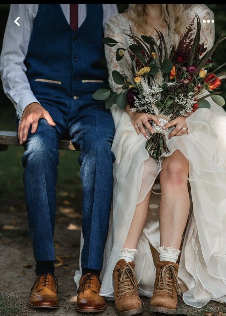 a bride and groom sitting on a bench together