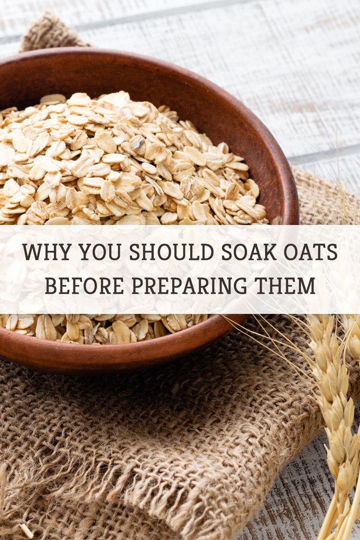 a wooden bowl filled with oats on top of a table