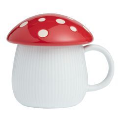 a red and white mushroom shaped coffee mug on a white background with the lid off