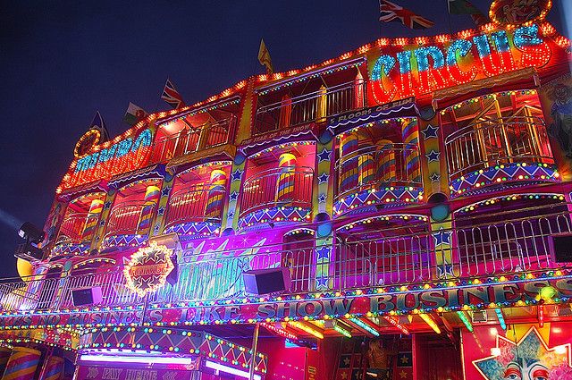 an elaborately decorated building with lights on it's sides and balcony balconies