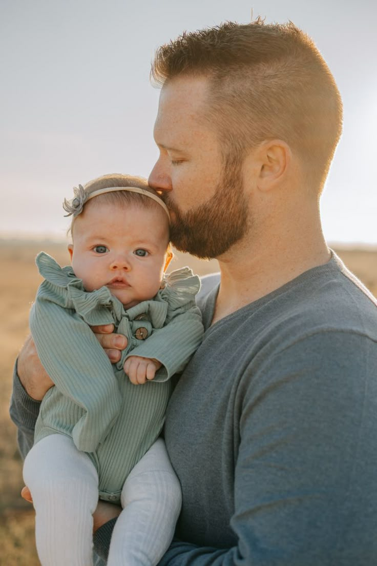 a man holding a baby in his arms