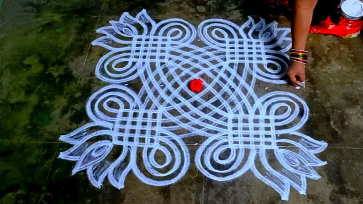 a person is standing on the ground drawing with chalk