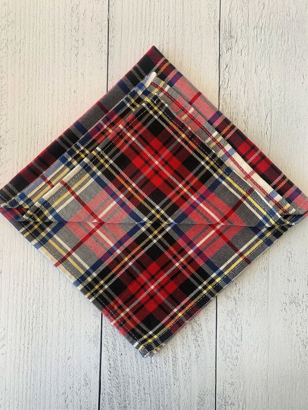 a red and black plaid pocket square on white wood