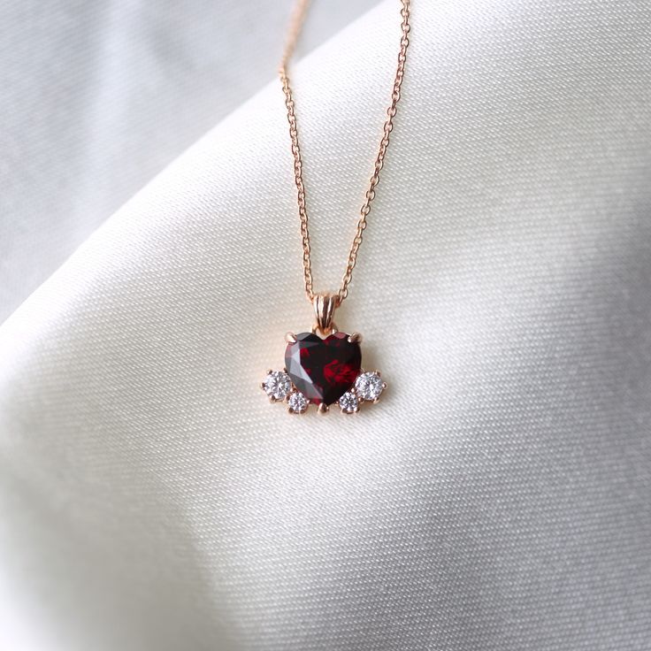 Garnet heart necklace 💝 * Details * Material : sterling silver with plate, 14k solid gold Color : Gold, white or rose gold Pendant Size : 11*8mm Heart stone : 7*7mm Round stone : 2.5mm, 1.7mm Chain Length : 16.5inch(If you want longer chain, please leave the length you need at the order note) We provide gift package with some our business card, Guarantee card, zip bag and caring tips card. Please check our shop policies and we love to hear from you about anything. Garnet Heart Necklace, Red Heart Necklace, Beautiful Pendants, Garnet Heart, Yule Ball, Star Charm Necklace, Heart Necklace Diamond, Diamond Solitaire Necklace, Gold Cross Necklace