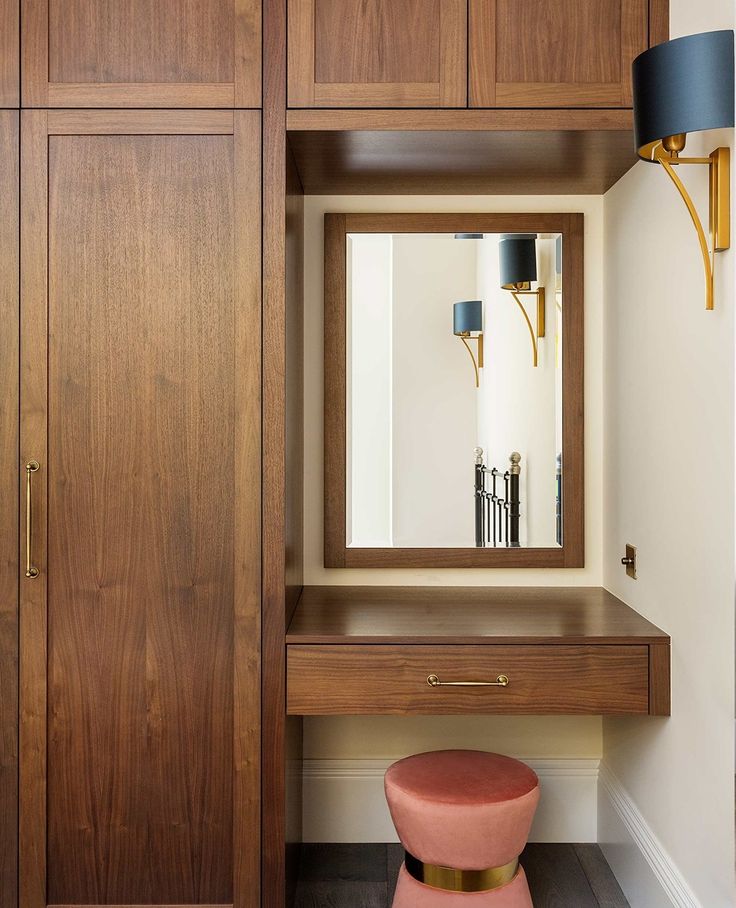 a dressing room with a mirror and stool