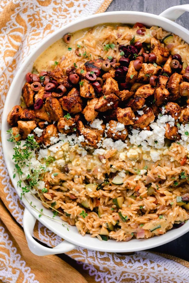 a white bowl filled with rice and meat