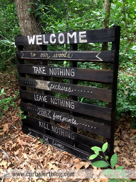 a wooden sign that says welcome to the woods, take nothing leave nothing kill nothing