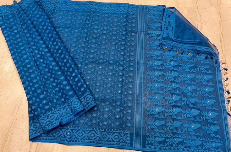 Bengal Traditional Soft Reshom Dhakai Jamdani in beautiful blue coliur . This gorgeous  saree depict the craftsmanship of Bengal weavers .  Saree is 5.5 Mt. Without blouse piece but can customise your choice of blouse material .  Fall and picot complimentary .    Please leave your phone no and email id while booking for shipping purpose. Feel free to contact me on my Whatsapp number ( to get just leave a message ) . Traditional Blue Pre-draped Saree With Dupatta, Traditional Blue Pre-draped Saree With Self Design, Traditional Blue Handloom Pre-draped Saree, Unstitched Blue Saree With Cutdana, Blue Saree With Cutdana Detailing, Traditional Blue Chanderi Saree, Blue Unstitched Saree With Pallu, Semi-stitched Blue Blouse With Traditional Patterns, Blue Chanderi Saree For Puja