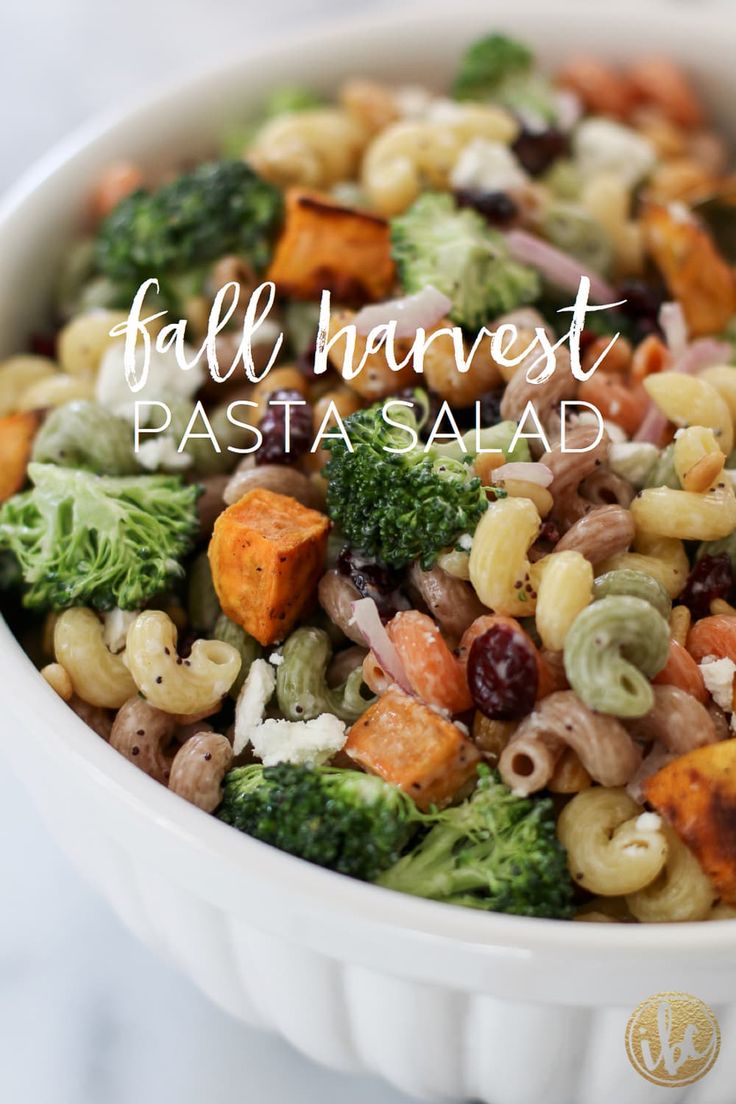 a white bowl filled with pasta salad and broccoli