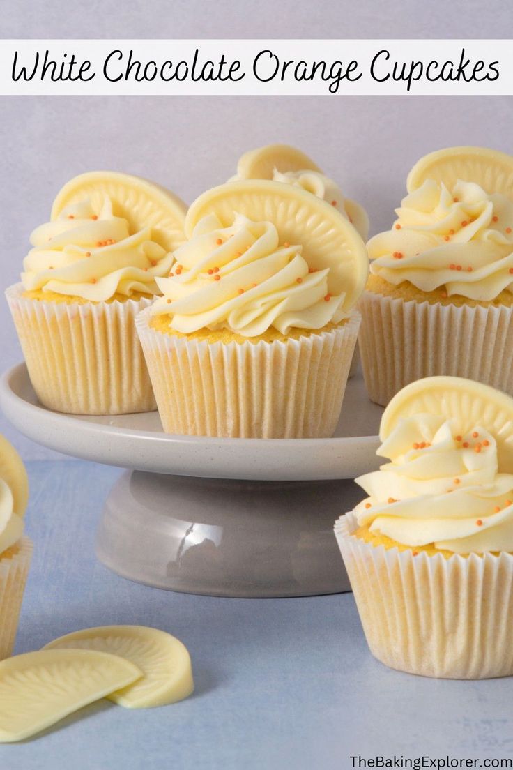 white chocolate orange cupcakes on a cake plate with banana slices around the edges