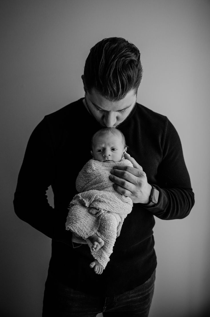 a man holding a baby in his arms