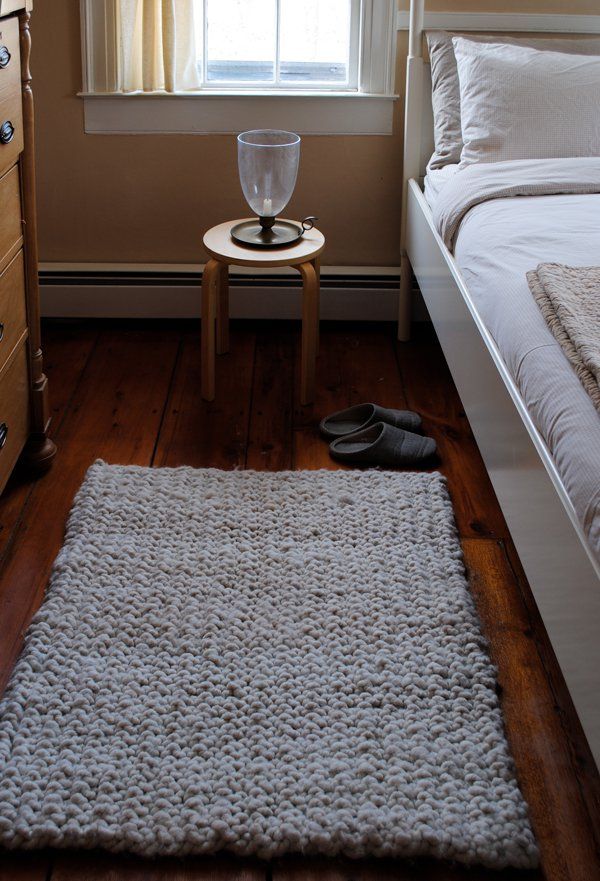 a bedroom with a bed, dresser and small table in front of the window that is open