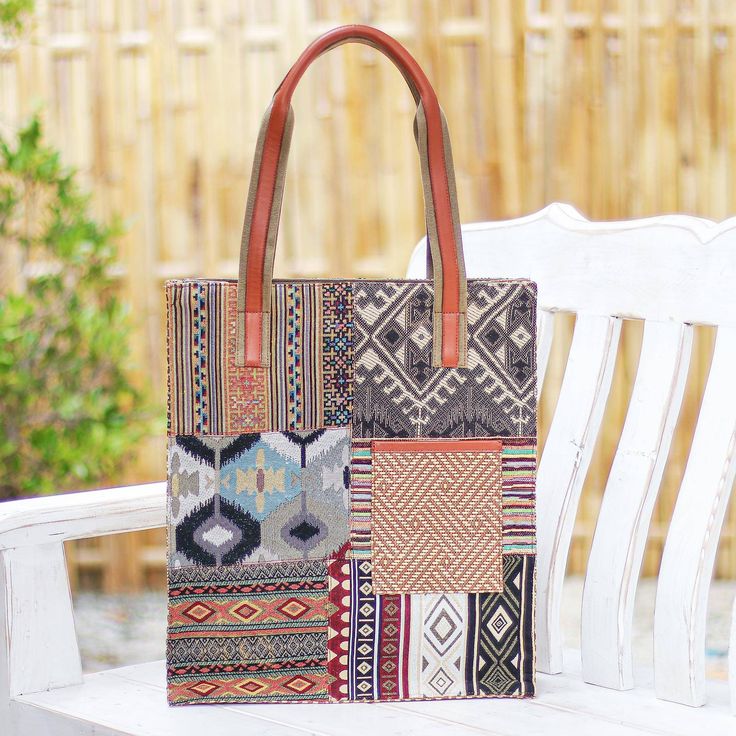 Designed with geometric motifs and lots of extra pockets Thai artisan Chirada's gorgeous tote bag is practical as well as stylish. Woven from a poly-cotton blend the bag features lots of contrasting designs and a cotton and leather handle. Inside one zippered pocket and two open pockets give you a place for odds and ends while a dark cotton lining keeps things cushioned. A zippered closure and two outside pockets finish the bag with thoughtful details. Bohemian Canvas Rectangular Bag, Multicolor Cotton Shoulder Bag With Leather Handles, Bohemian Canvas Bag With Leather Handles, Travel Patchwork Tote Satchel, Travel Tote Bag With Patchwork, Rectangular Bags With Geometric Pattern, Bohemian Tote Bag With Pockets, Geometric Pattern Travel Bag Rectangular, Eco-friendly Patchwork Bags For Daily Use