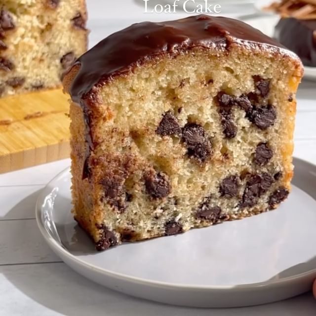 a close up of a piece of cake on a plate with chocolate chip toppings