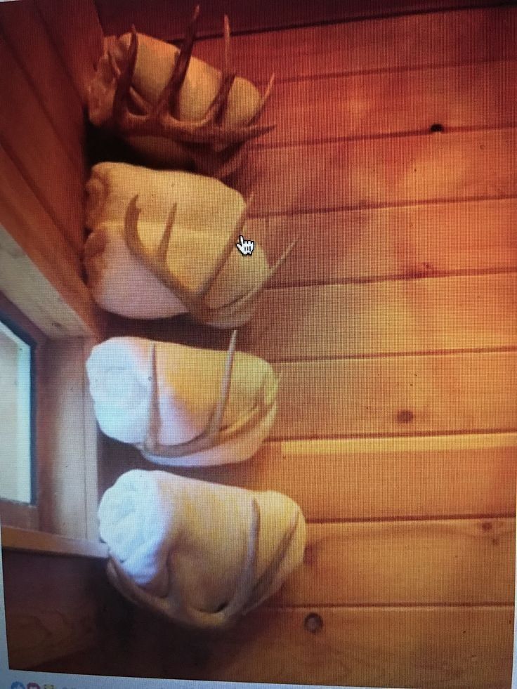 three towels are stacked on top of each other in the corner of a wooden room