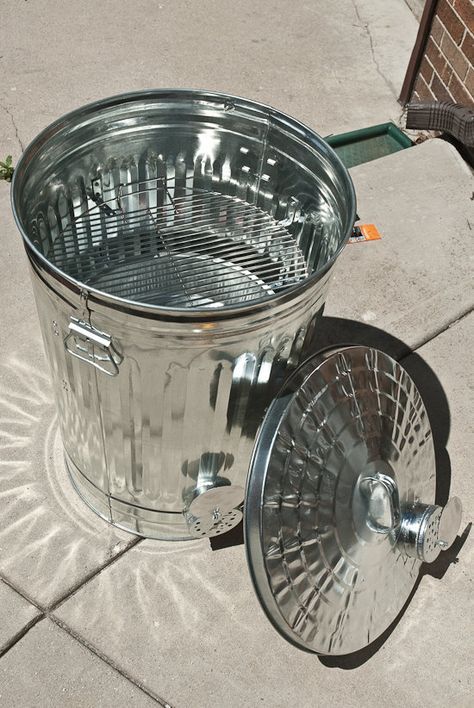 a large metal bucket sitting on top of a sidewalk