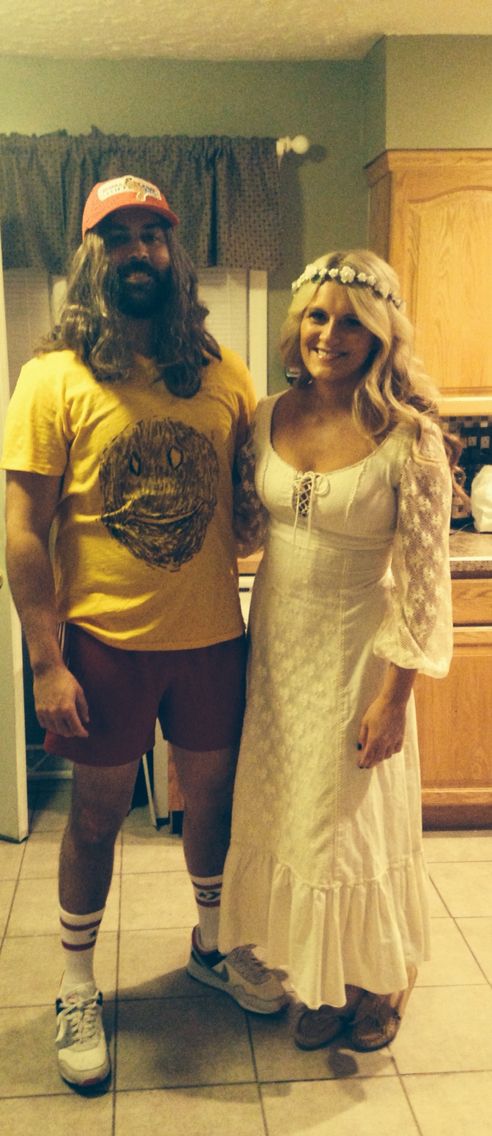 a man and woman dressed in costumes standing next to each other on the kitchen floor