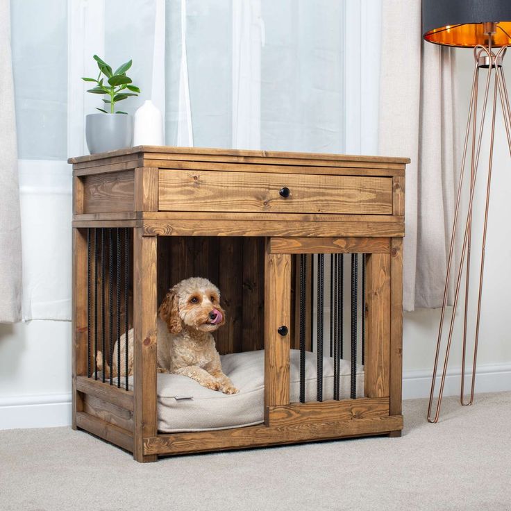 a dog sitting in its cage on the floor