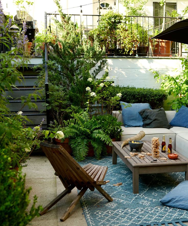 an outdoor living area with furniture and plants